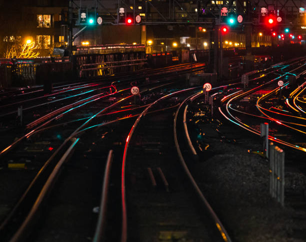 istock Railway tracks illuminated at night in the city 1309322140