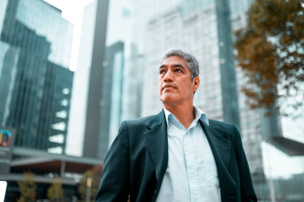 Low angle photo of businessman Low angle photo of businessman looking away low angle view stock pictures, royalty-free photos & images
