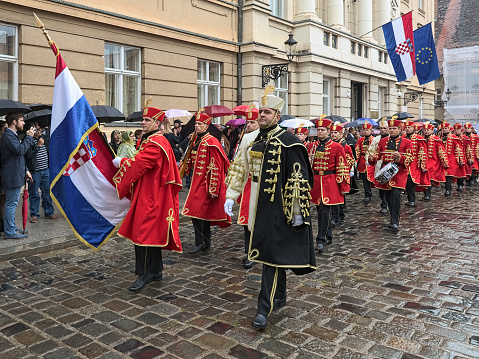 Zagreb, Croatia - October 8, 2018:  Honorary Company of the Honor Guard Battalion in the ceremonial dress marches with National flag along the Croatian Parliament building on St. Mark's Square during the celebration of Croatian Independence Day on October 8, 2018.