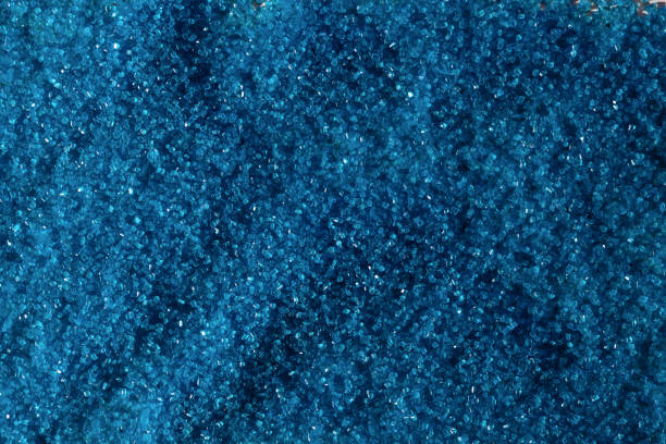 istock Blue colored edible sugar - sweet cake decoration on white background. 1309325842