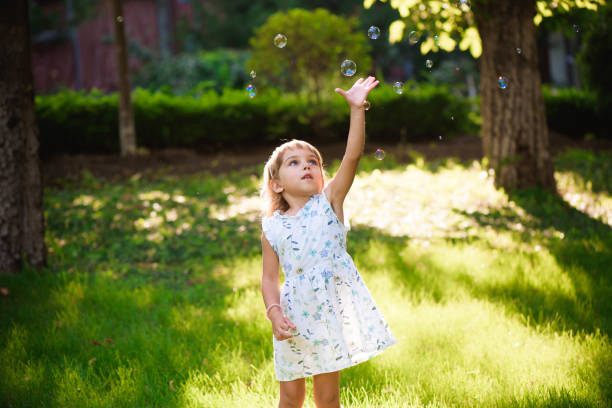 istock Girl with bubbles at a sunny summer evening 1309326836