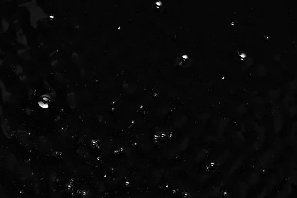 istock Bubbles on the surface of the liquid. Abstract Black Background Liquid Texture 1309326940