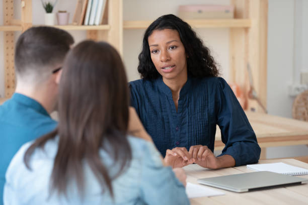 Biracial female consultant have meeting with couple clients