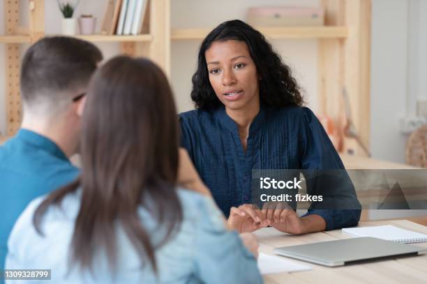 Biracial Female Consultant Have Meeting With Couple Clients Stock Photo - Download Image Now