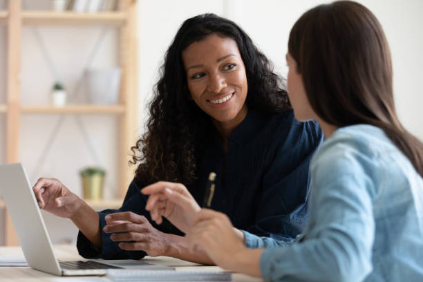 istock Smiling multiracial female colleagues cooperate in office 1309328802