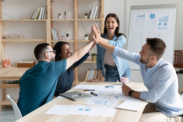 istock Happy diverse employees celebrate success at meeting 1309328830