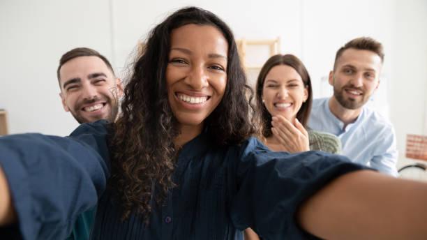 istock Wide view of happy colleagues make selfie in office 1309328836