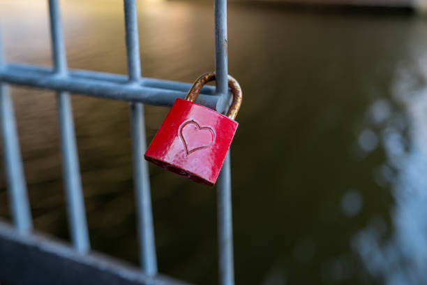 istock red padlock on which is engraved a heart hangs on a fence 1309329232