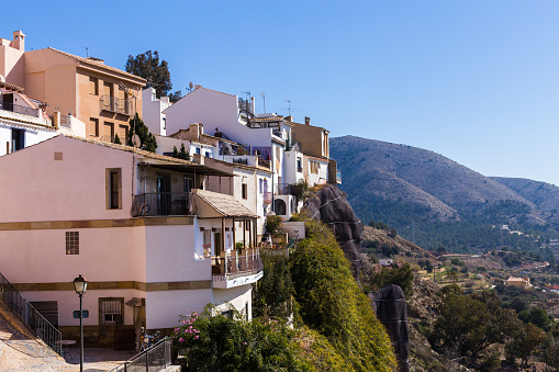 The facades of the white houses of the Spanish old town of Finestrat are built in the mountains