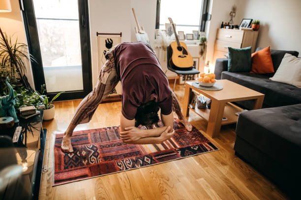 istock Young man doing yoga at home 1309336898