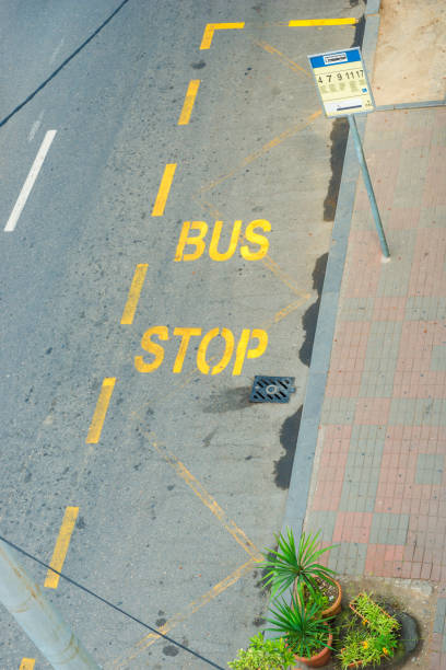 la chaussée marque la vue supérieure de l’arrêt d’autobus - stop mot anglais photos et images de collection