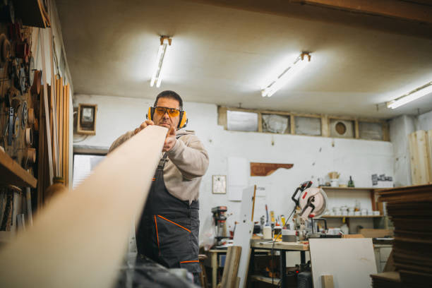 istock Carpenter cutting wooden plank 1309343942