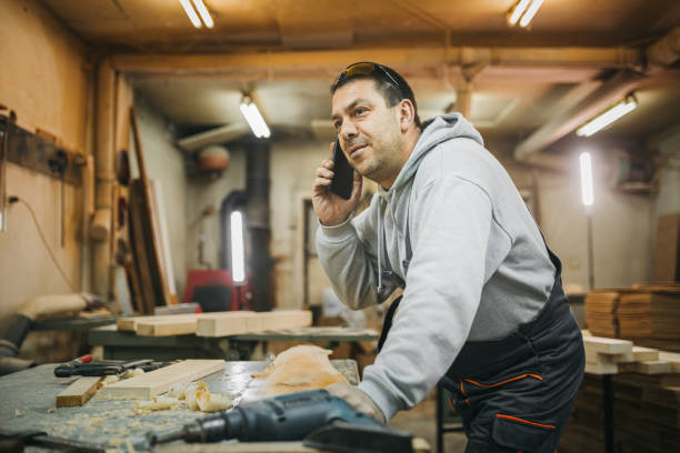 istock The carpenter uses the phone 1309345601