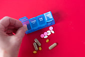 hand-putting-pills-in-pille-organizer-ro