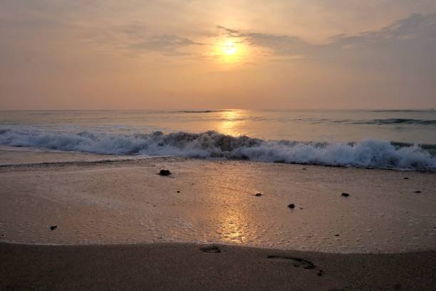 istock In selective focus silhouette sunrise with golden light on water surface and clean waves 1309354042