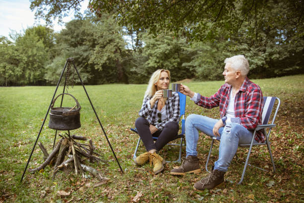 istock Beautiful senior couple enjoying on camping in nature 1309354591