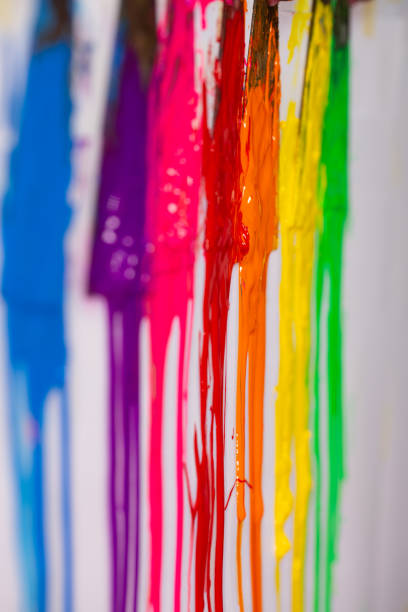 istock Orange is dripping from the handle of the paint scoop. 1309358545