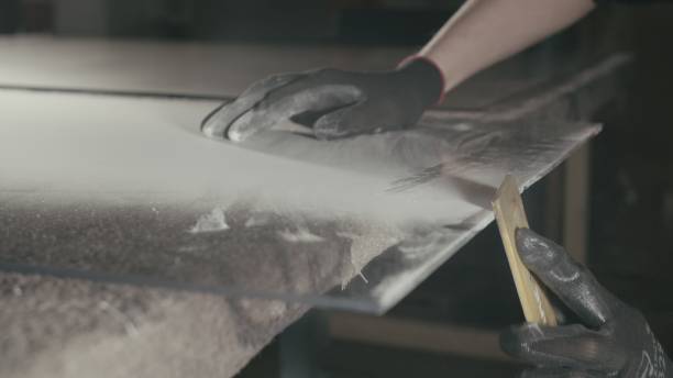 istock Glass cutting and processing for fireplace doors. Circular glass cutter. Worker cut glass with glass cutting diamond. 1309359449