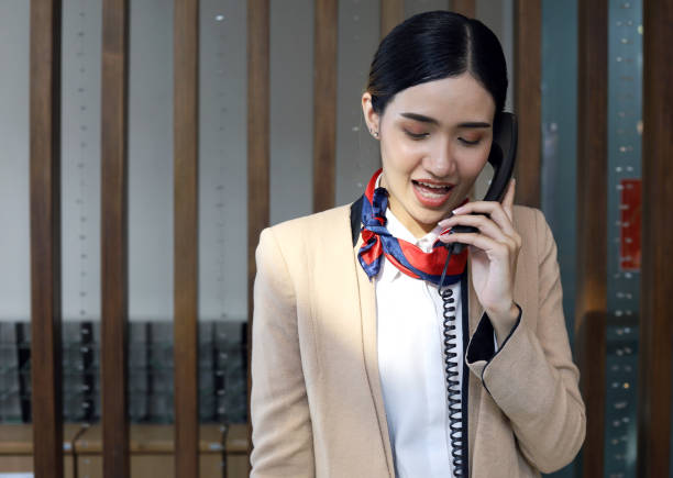 istock Beautiful Asia woman reception calling welcome customer at hotel. 1309361164