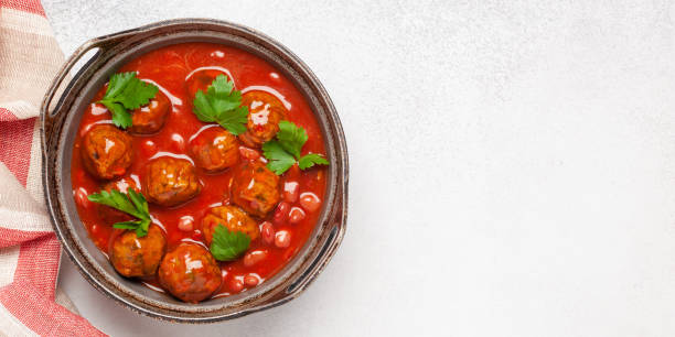 istock Meat or vegetable meatballs in tomato sauce with beans. Top view. 1309362209