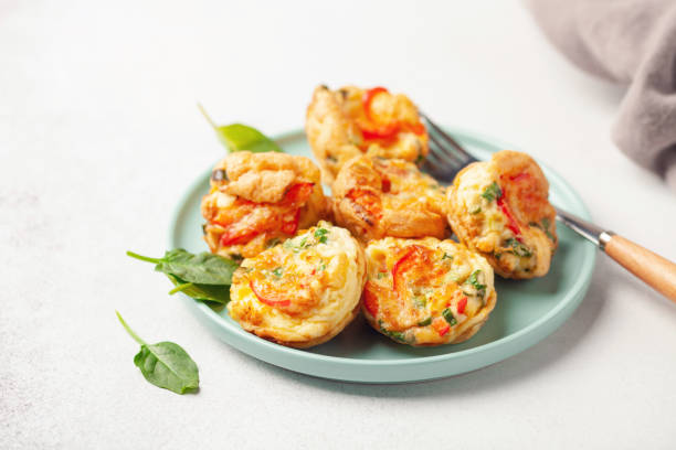 istock Egg muffins ( bites) and spinach leaves  in a plate on a gray background 1309362243