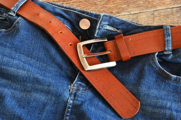 istock Brown Leather Belt and Blue Jeans Close Up 1309363022