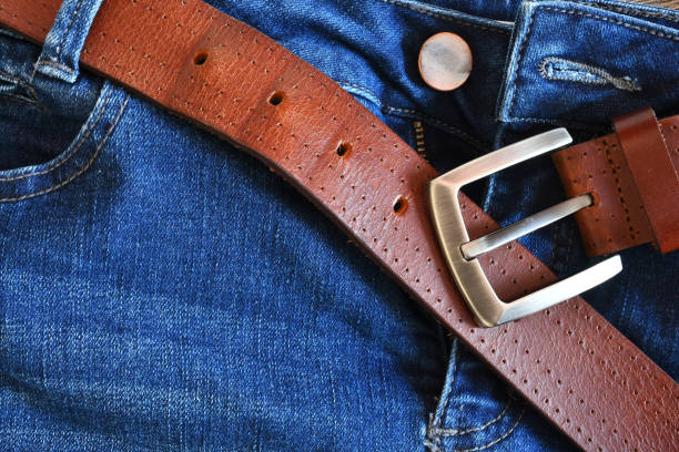 istock Brown Leather Belt and Blue Jeans Close Up 1309363546