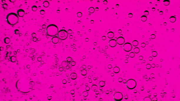 istock Oil bubbles on the water surface in motion, on a purple background, macro, splash screen, template, copy space 1309364358