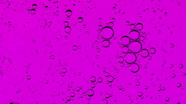 istock Oil bubbles on the water surface in motion, on a purple background, macro, splash screen, template, copy space 1309364368