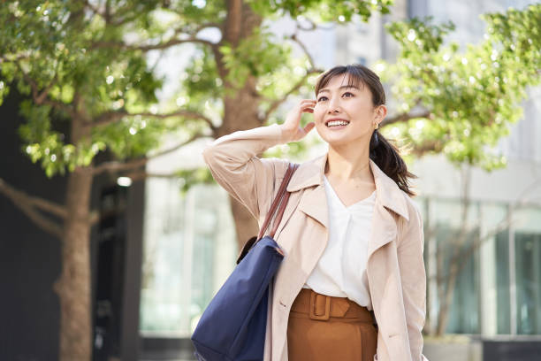 Asian business woman walking in the business district Asian business woman walking in the business district japanese woman stock pictures, royalty-free photos & images