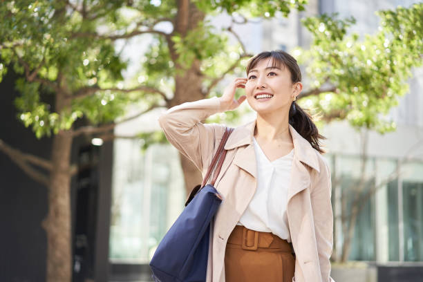 asian business woman walking in the business district - female women young women one young woman only imagens e fotografias de stock