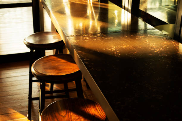 metal table and wood inside restaurant with sunlight from window interior background