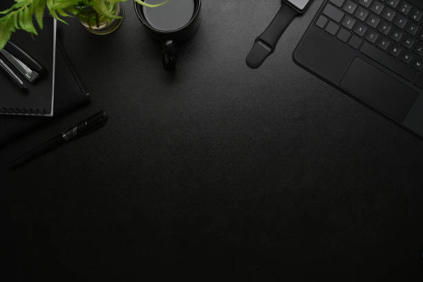 istock Modern workplace with smart watch, coffee cup, keyboard, notebook and copy space on black leather. 1309370850