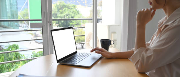 istock Side view of businesswoman using computer laptop surfing internet at office. 1309371033