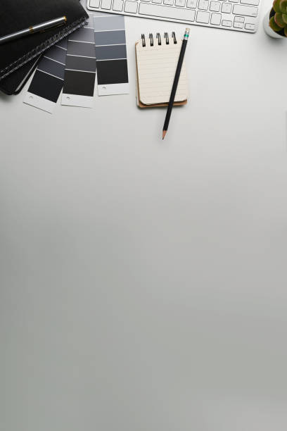 istock Creative designer workplace with notebook, color swatches, keyboard and copy space on white background 1309371037
