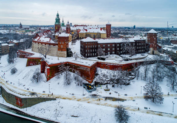 Wawel Castle and Cathedral in winter. Krakow, Poland Krakow, Poland - January 14, 2021: Historic royal Wawel Castle and Cathedral in winter with white snow, walking people and promenade. wawel cathedral photos stock pictures, royalty-free photos & images