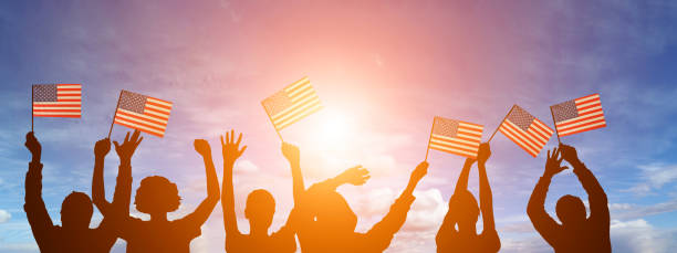 istock USA flag on sky background. American holidays 1309375287