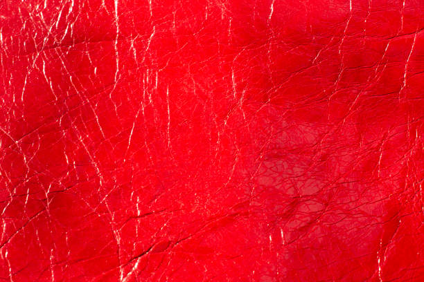 istock Red textured patent leather for design template and background.Shoe industry 1309375516