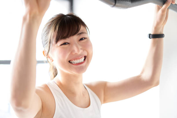 Asian woman pulling down a rat with a smile