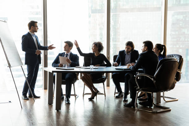 istock Confident female employee interact with coach at presentation 1309380763