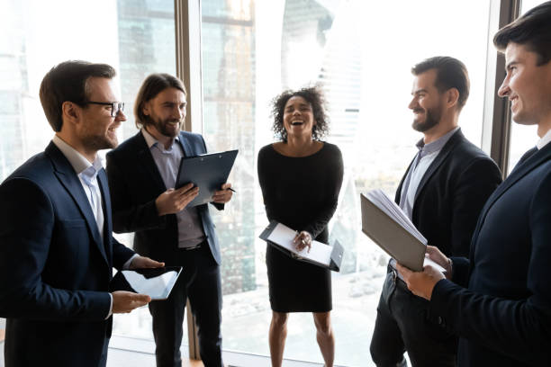 istock Overjoyed diverse businesspeople laugh brainstorming in office 1309380785
