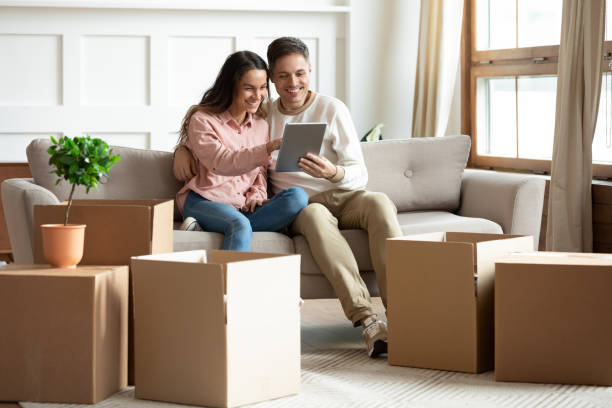 istock Couple using tablet buy goods online relocated at new home 1309383497