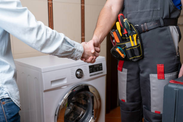 Close-up of a repairman shaking hands with a female customer. Male repairman for washing machine repair Close-up of a repairman shaking hands with a female customer. Male repairman for washing machine repair. Plumber stock pictures, royalty-free photos & images