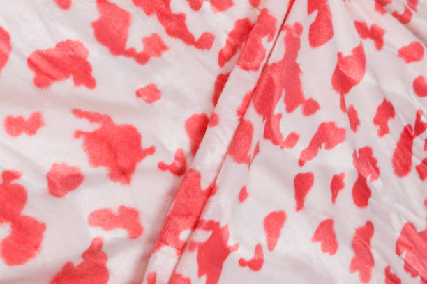 istock Colored red textile satin fabric folded in folds and waves with highlights and texture 1309384553