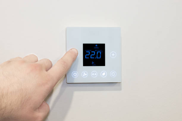 istock Close-up of a digital thermostat being adjusted 1309384615