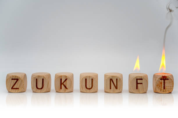 Seven partly burning cubes with the German word for future as a symbol for fear of the future icon picture zukunft stock pictures, royalty-free photos & images