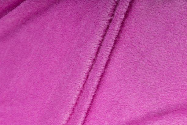 istock Colored rose textile satin fabric folded in folds and waves with highlights and texture 1309384675