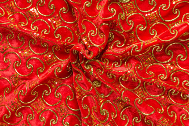 istock Colored red textile satin fabric folded in folds and waves with highlights and texture 1309384721