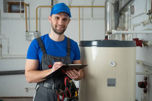 Technician servicing an hot-water heater. Man check equipment of the boiler-house - thermometer Technician servicing an hot-water heater. Man check equipment of the boiler-house - thermometer boiler stock pictures, royalty-free photos & images