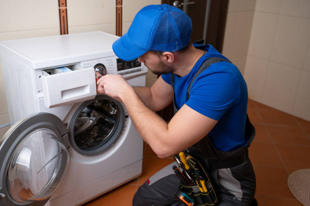 istock Worker repairing washing machine in laundry room 1309386090